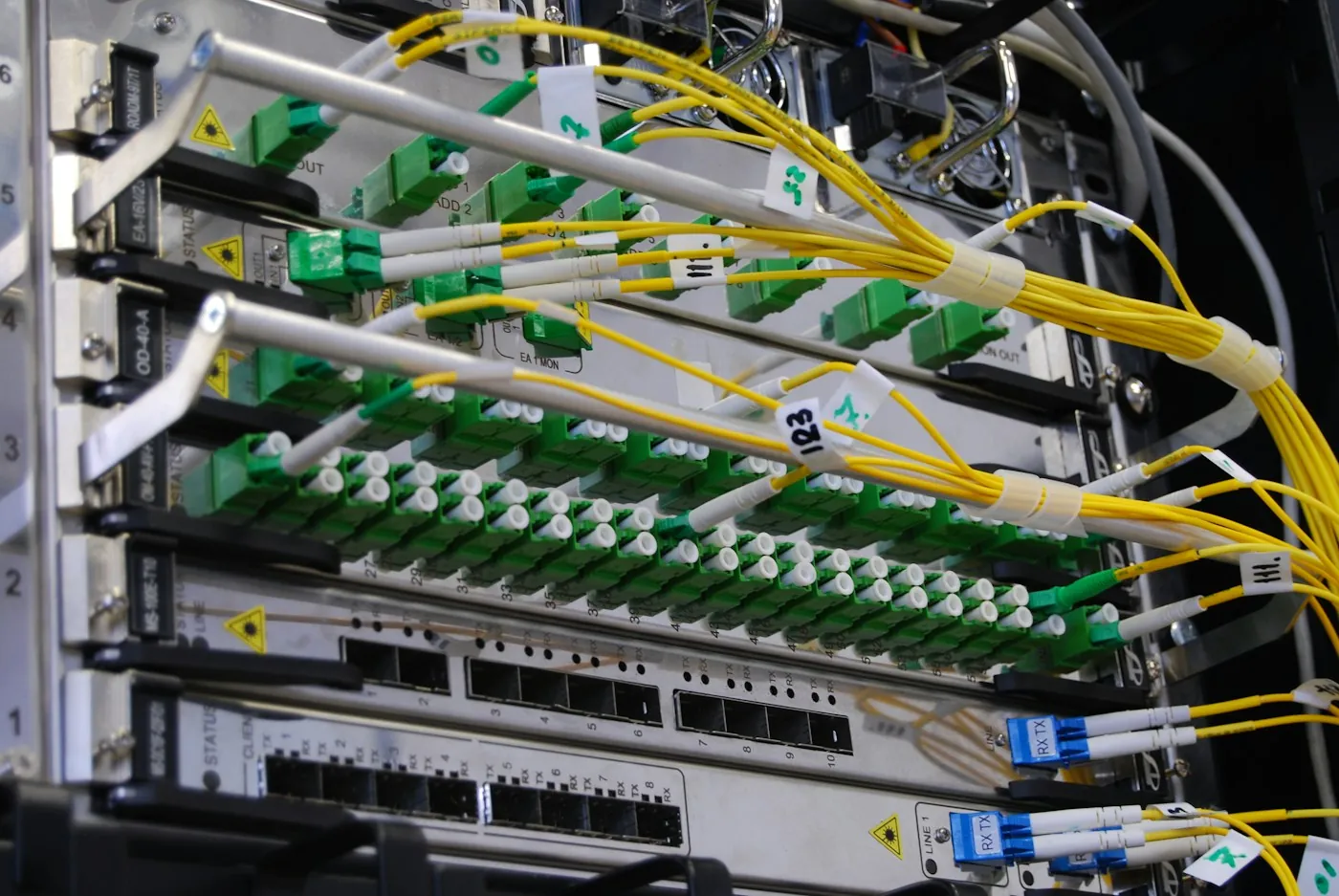 Fibre optic cables connected to a network switch in a server rack